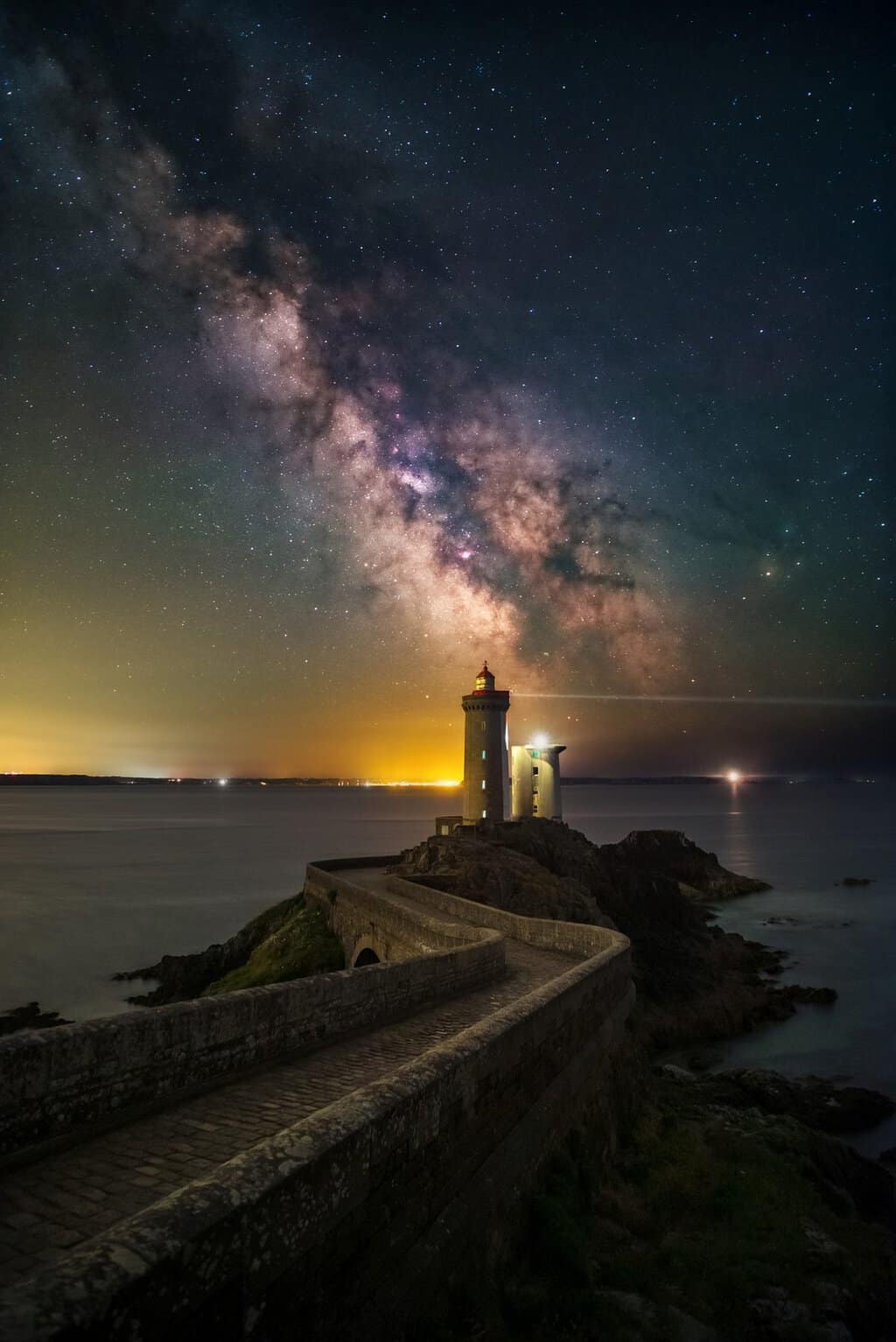 Milky Way over a coastal lighthouse by Evgeni Tcherkasski