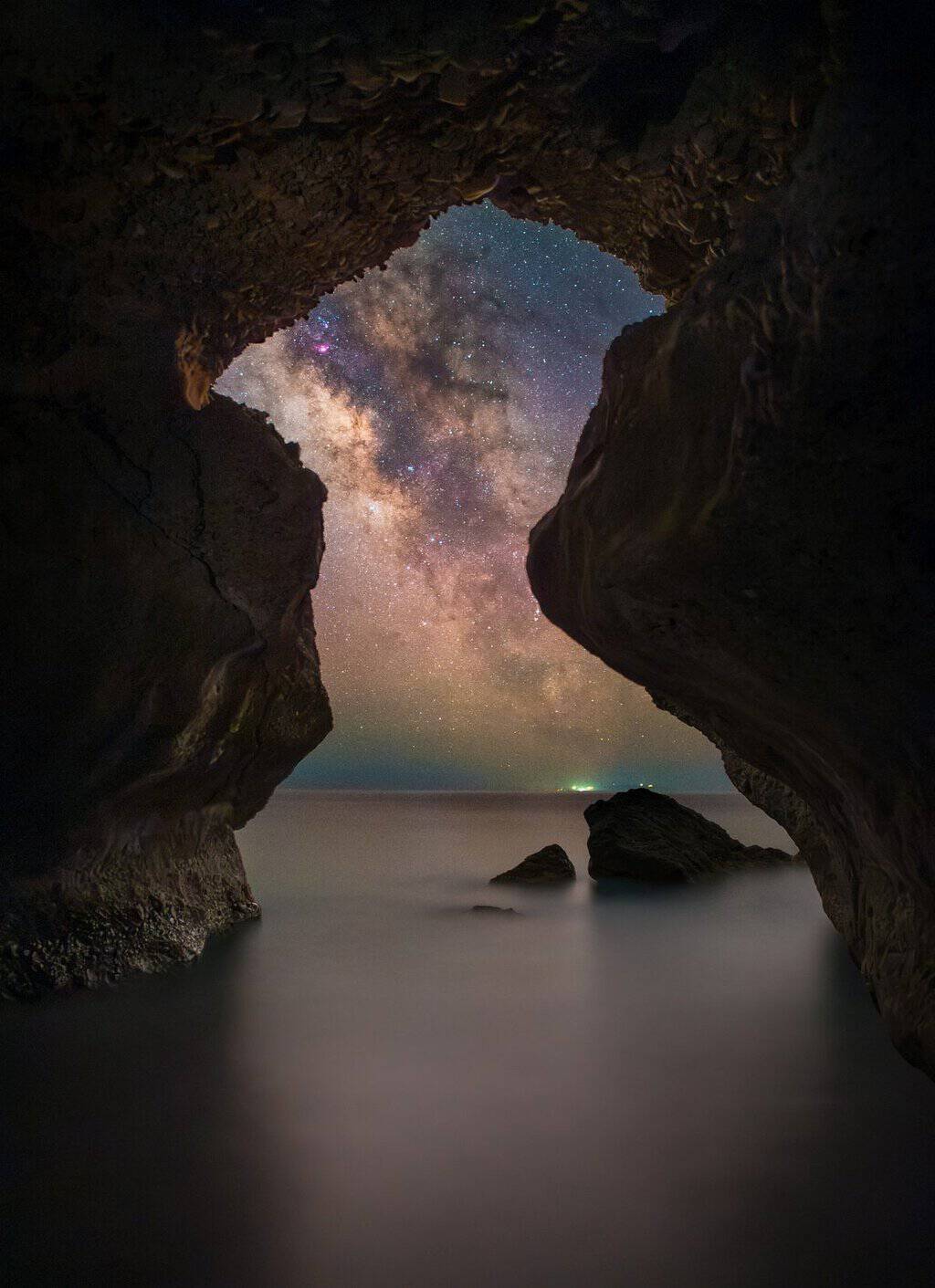 Milky Way framed through a sea cave by Evgeni Tcherkasski